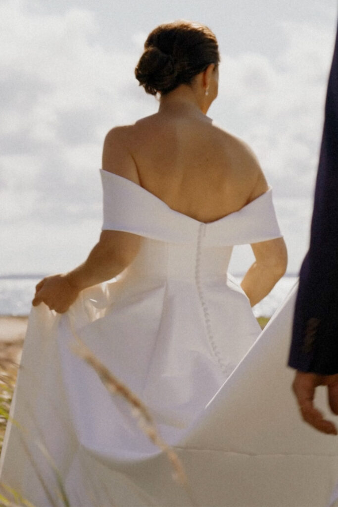 Bride walking in grass
